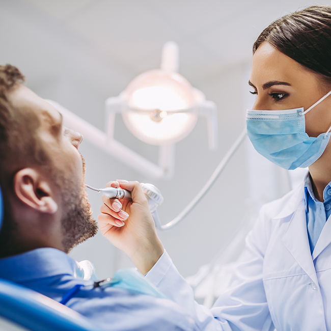 Dentist examining patients teeth
