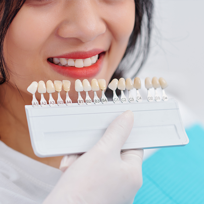 Dentist matching patients tooth shade